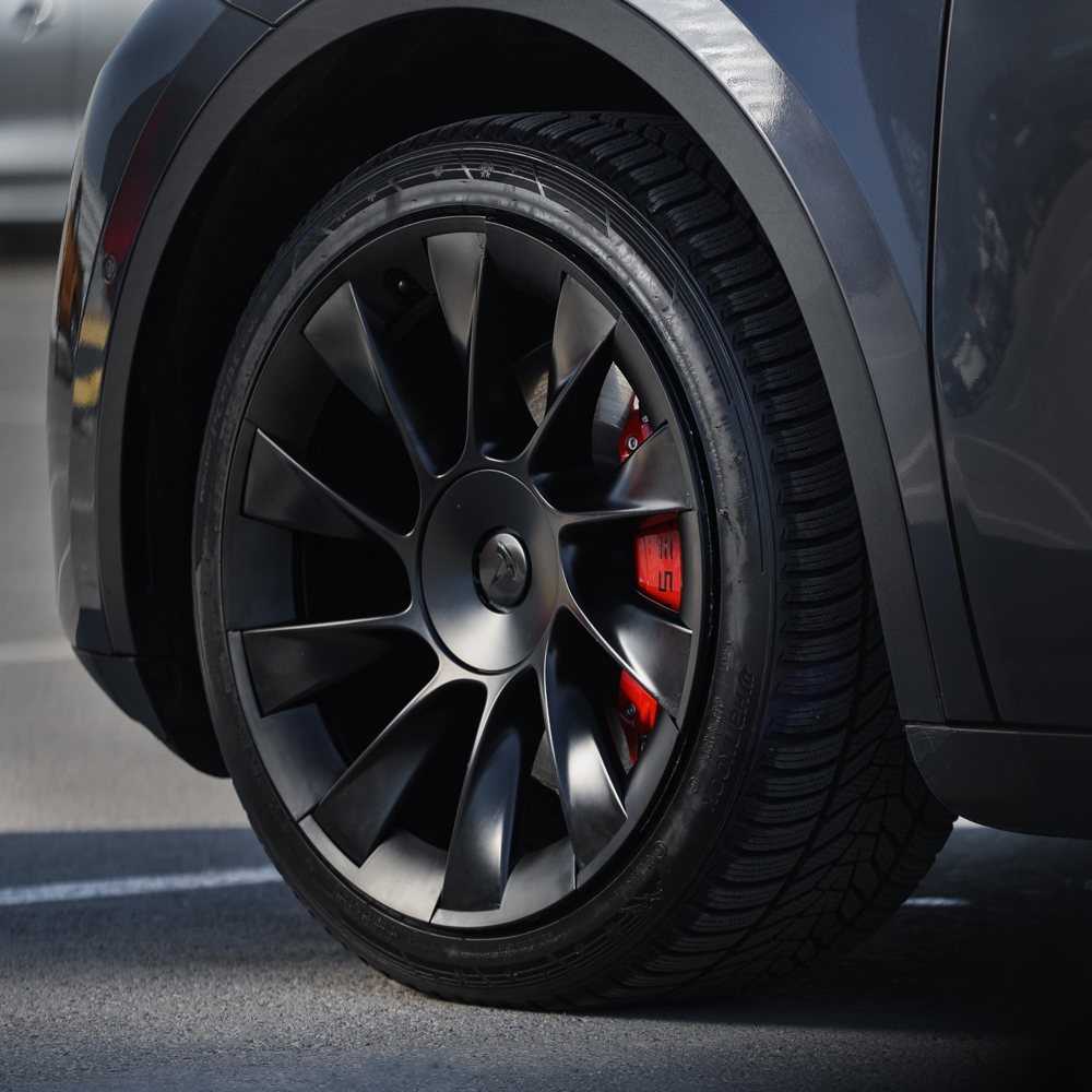 Product photo: TeslaHubs Performance Red caliper cover behind a black Tesla wheel